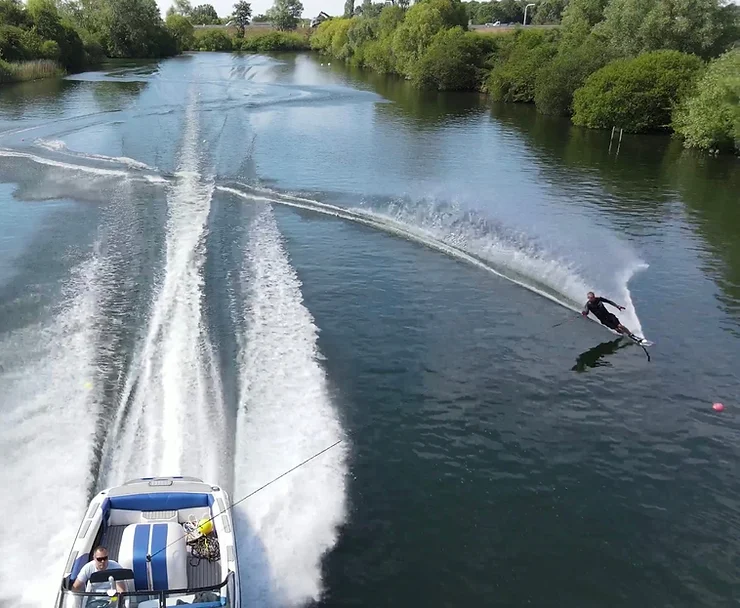 Person waterskiing on a lake behind a boat