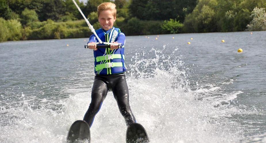 Image of a young person learning how to waterski