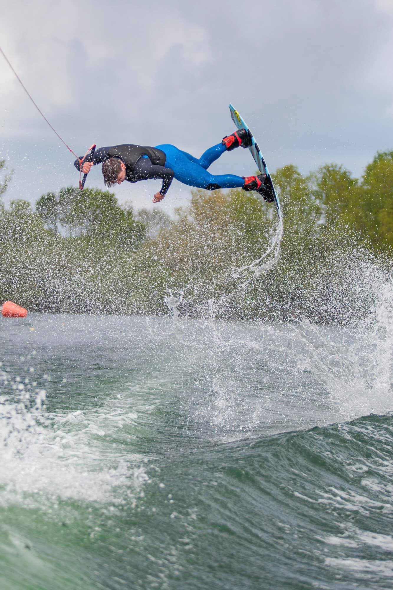 Picture of a person doing an inverted trick on a wakeboard
