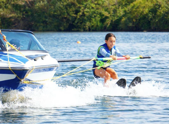 Image of a young person on a boat training boom